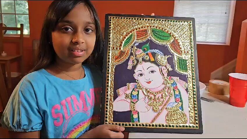 Student with their finished painting