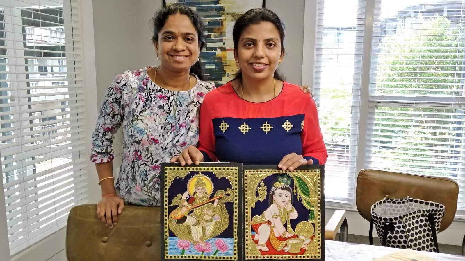 Two students with their completed Tanjore paintings