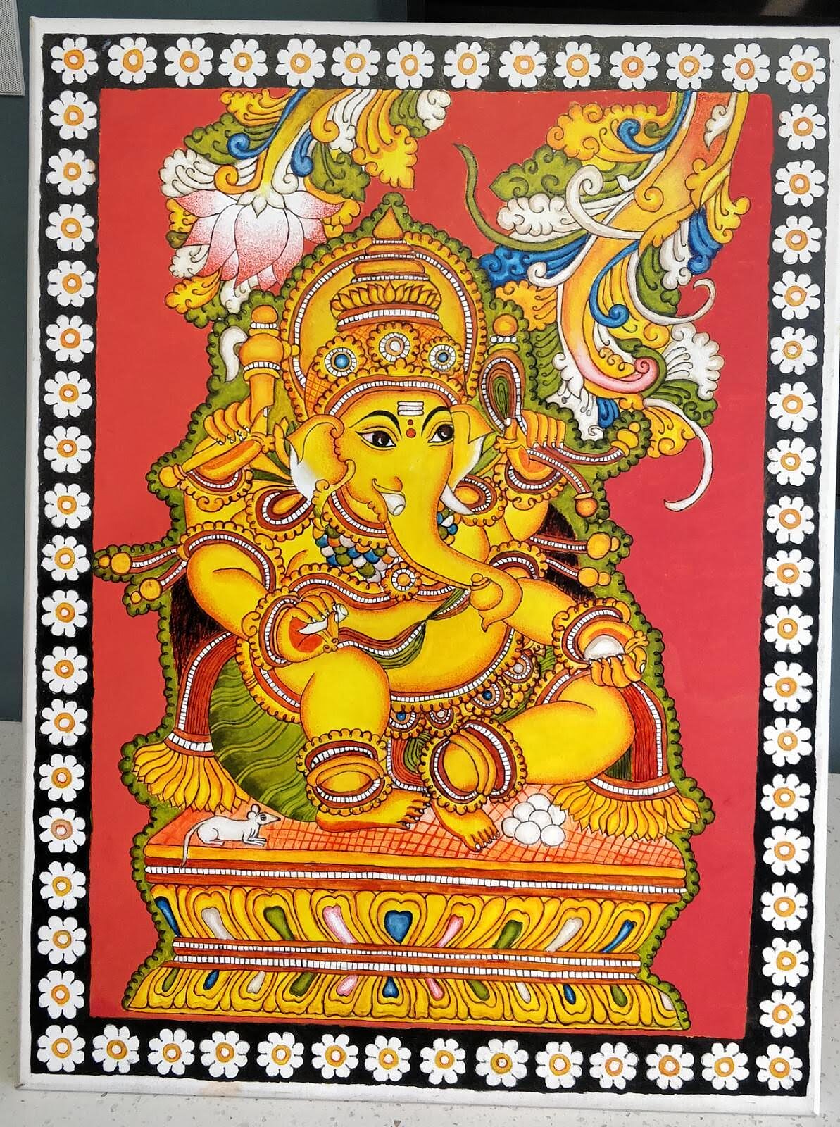 Student holding their Kerala Mural painting