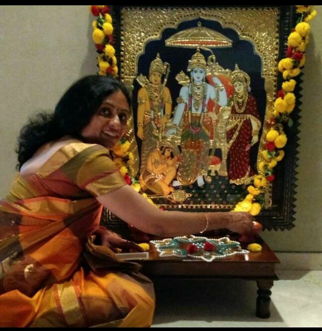 Student offering puja before her completed Rama-darbar Tanjore painting